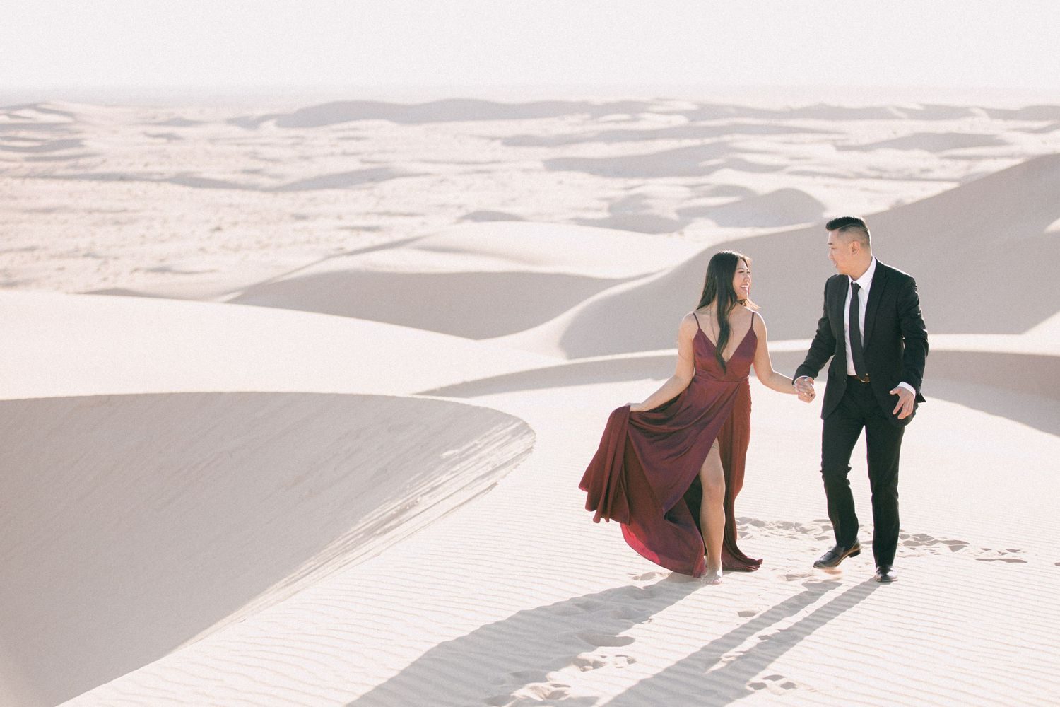 A couple tiny on vast white sand dunes at Glamis