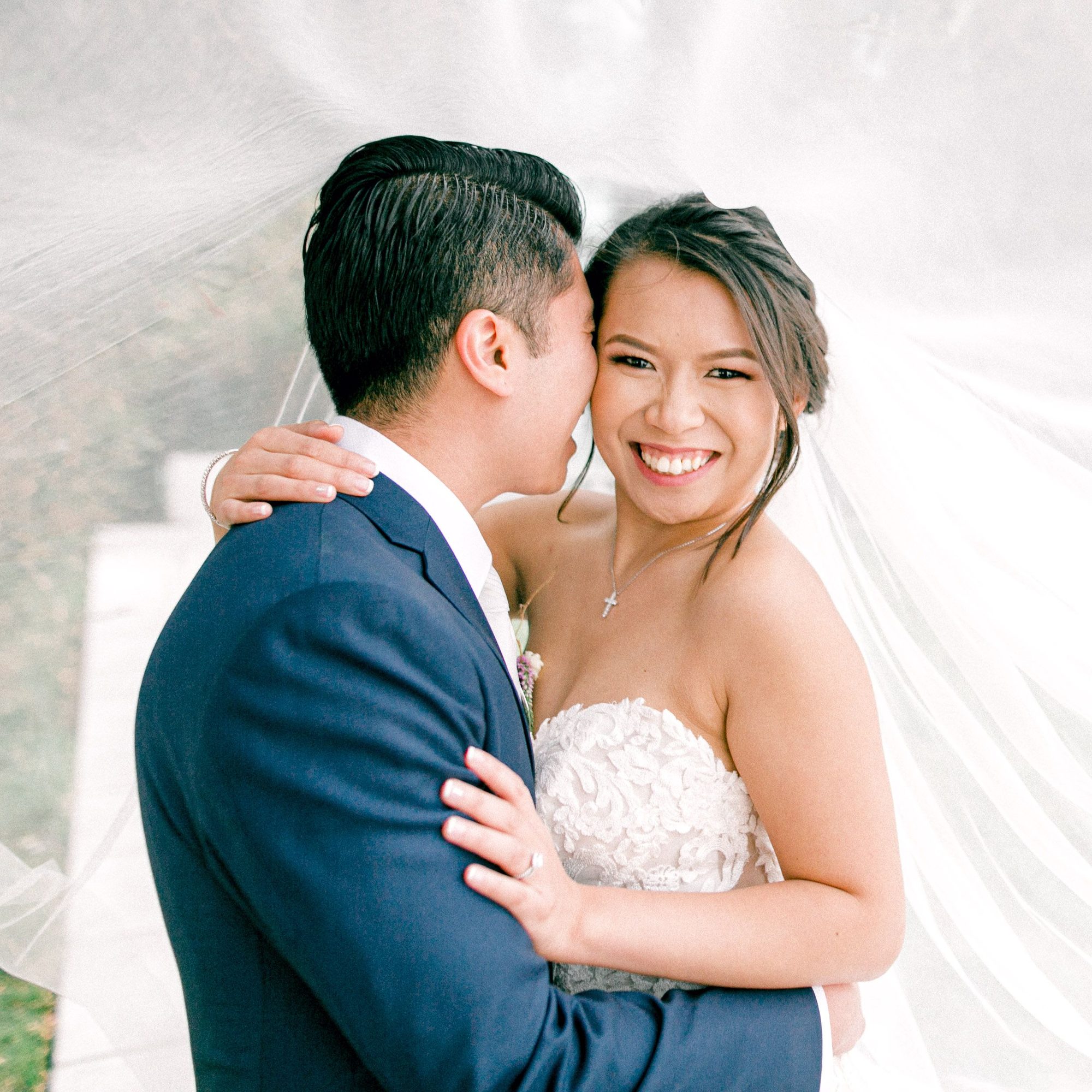 Laughing embrace under the veil