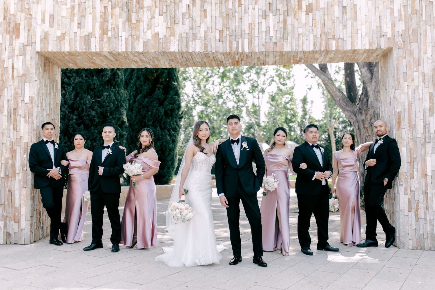 Bridal party at a stone gateway