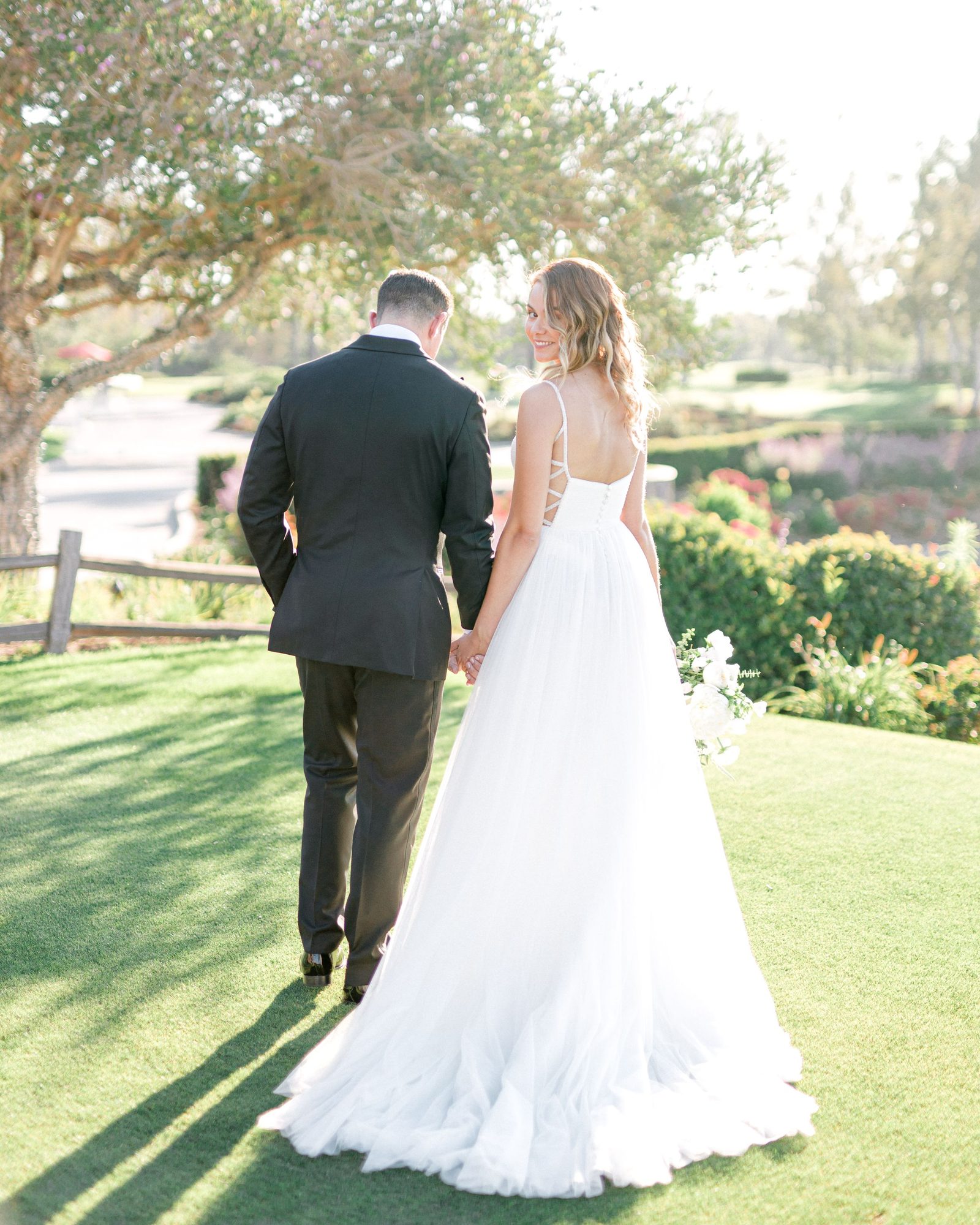 Couple walking away across a lawn